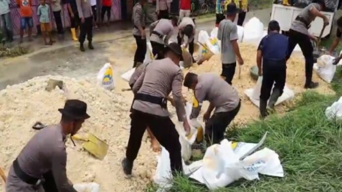 Personil Polresta Cilacap Membantu Perbaikan Tanggul yang Jebol di Desa Bantarsari
